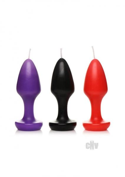 Set of three Ms Kink Inferno Drip Candles in purple, black, and red shaped like butt plugs for wax play with a low melting point and moisturizing paraffin wax.