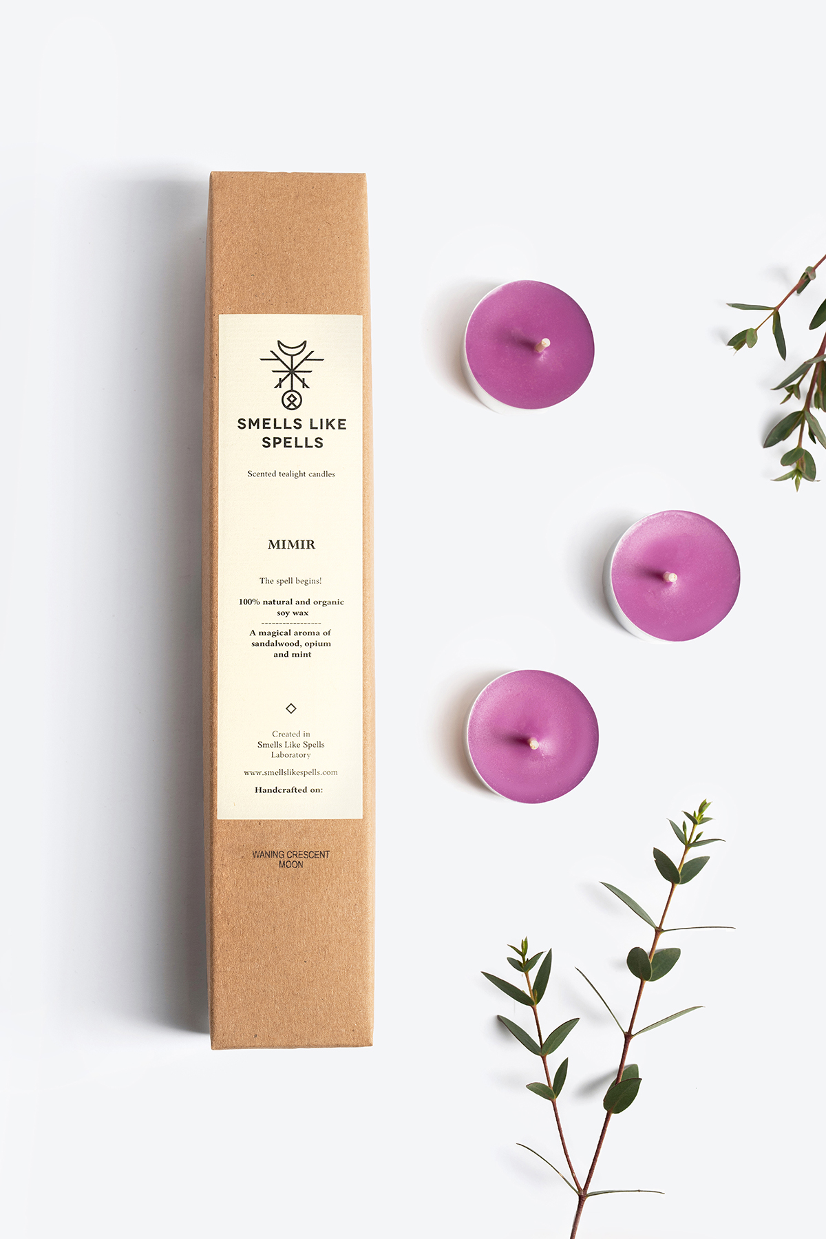 Scented tealight candles MIMIR with lavender, sandalwood, and opium aromas, presented in eco-friendly packaging alongside eucalyptus sprigs.
