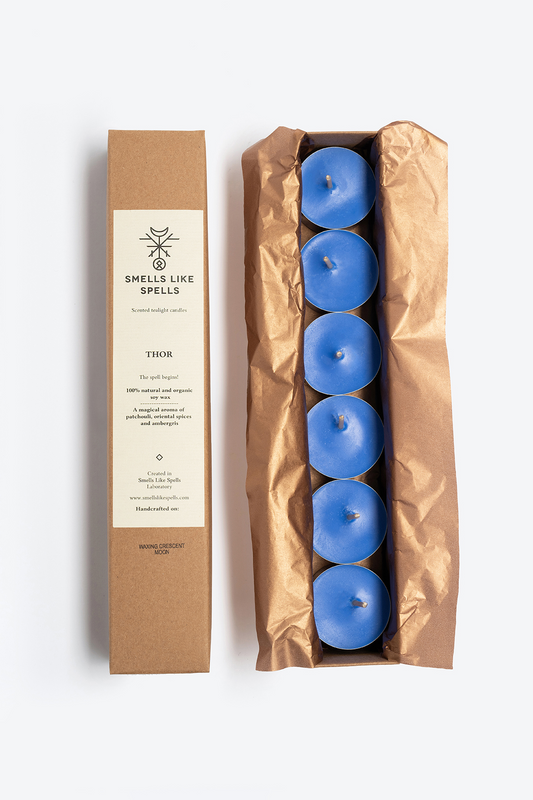 Set of six blue scented tealight candles named THOR with patchouli, oriental spices, and ambergris aroma, packaged in a brown box with eco-friendly wrapping.