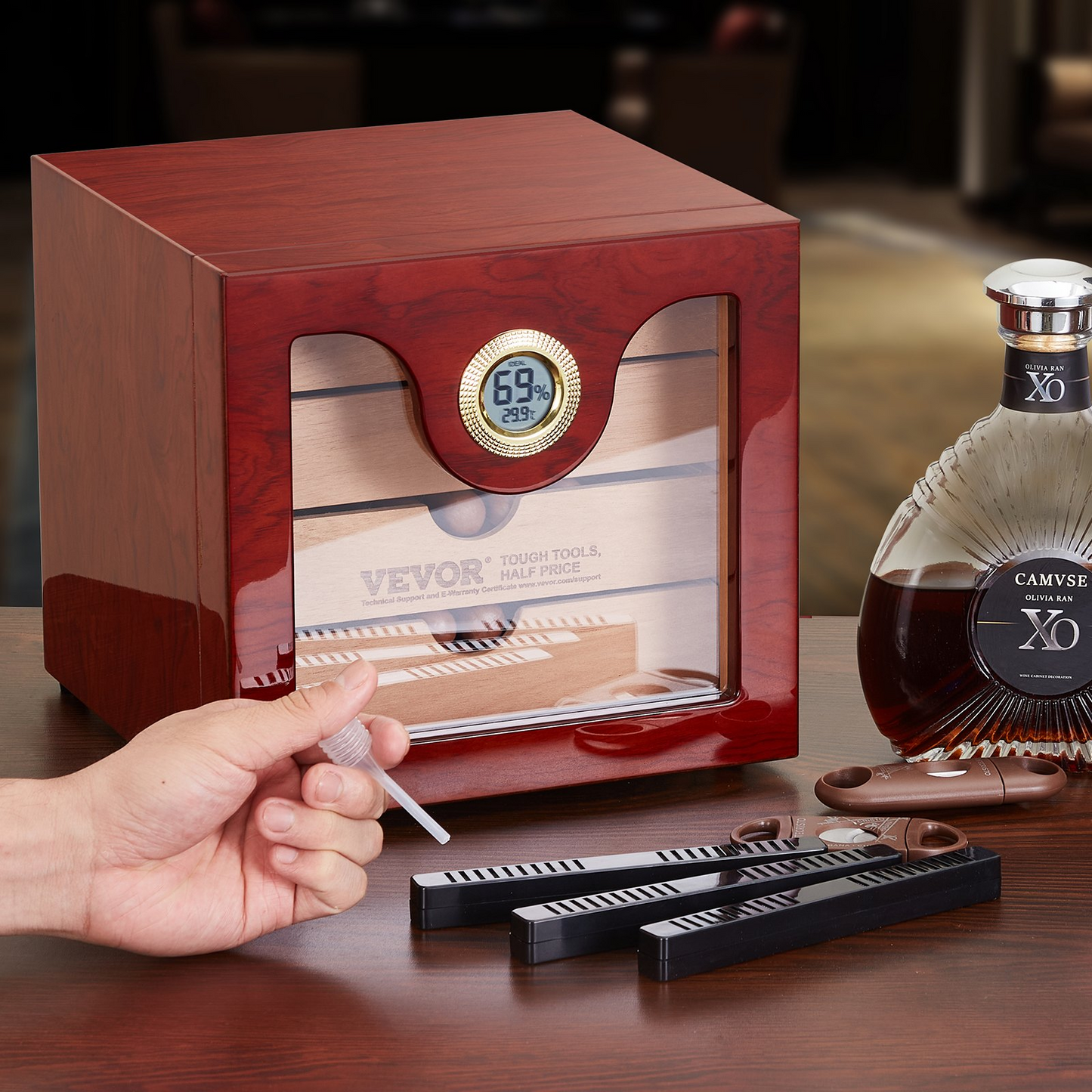 VEVOR 100 Cigar Humidor cabinet in polished cedar wood with built-in humidifier and hygrometer on table with cigar accessories and bottle.