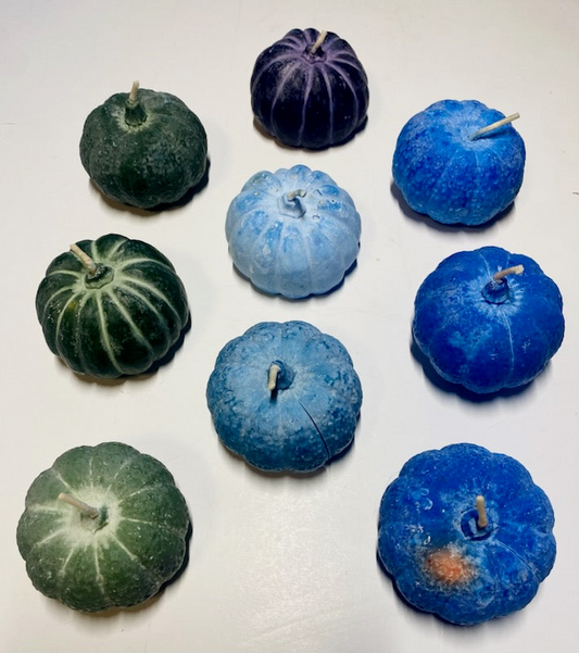 Handmade cool color pumpkin soy candles in blue, green, and purple shades with seasonal essential oil scent.
