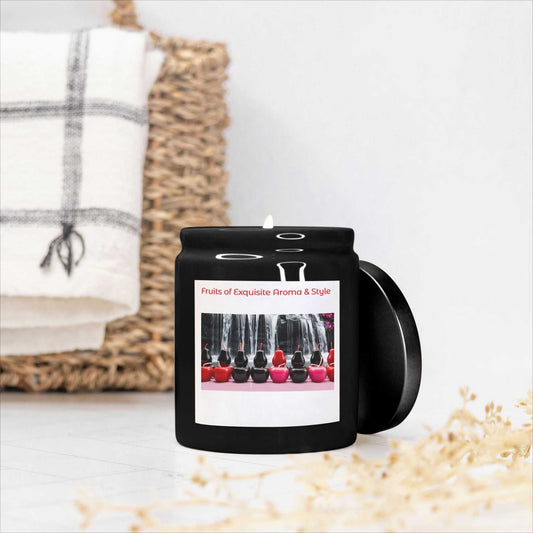 Black 8oz ceramic candle with Fruits of Exquisite Aroma label and lit wick on white surface.